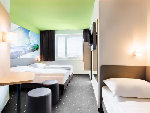 Postel nebo postele na pokoji v ubytování B&B Hotel Villach