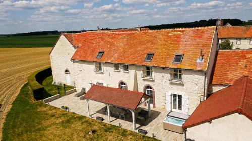 an aerial view of a large building with red roofs at Domaine des Hirondelles - Escapade de Charme & Spa à 15min de Provins in Champcenest