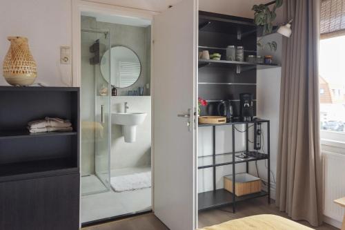 a bathroom with a shower and a sink at Appartement Zuid 5 in Zandvoort