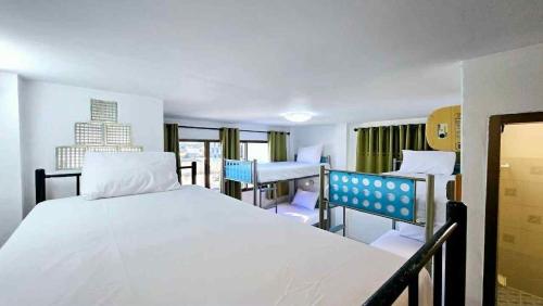 a hospital room with a bed and two desks at MT friendhome&hostel2 in Phuket