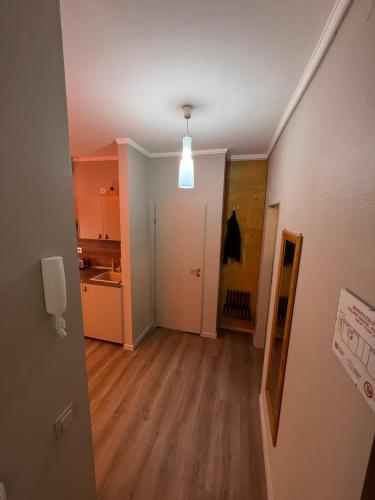 an empty room with a kitchen and a hallway at Fonte Salis Apartman in Egerszalók