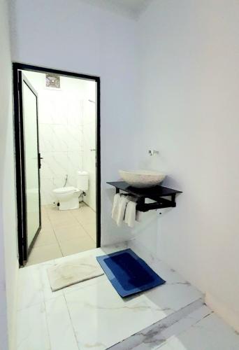 a bathroom with a sink and a mirror at Villa Cozy Kapal 1BR private pool in Badung