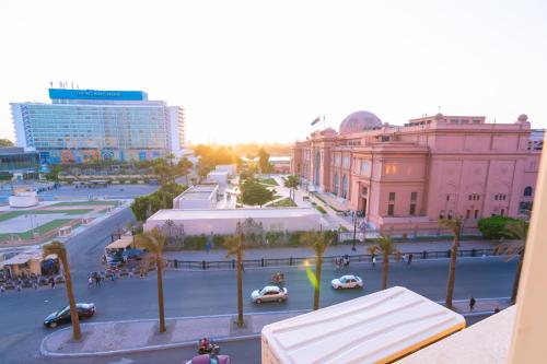 a city street with cars and palm trees and buildings at Elevana Boutique hotel in Cairo