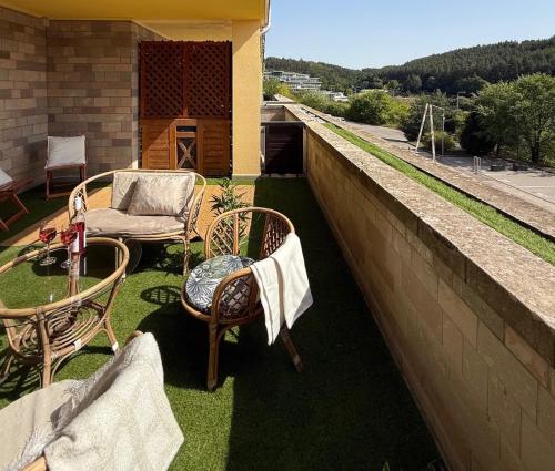 a patio with two chairs and a table on a balcony at Fonte Salis Apartman in Egerszalók