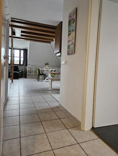 a hallway with a tile floor and a dining room at Ferienwohnung 2 ANNA IFF in Würzburg
