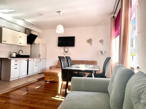 a living room with a couch and a table at Familly Apartament 3 in Międzyzdroje