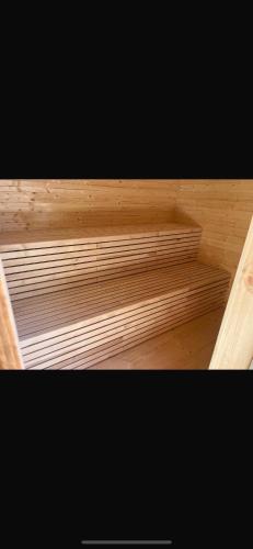 a wooden shelf in a room with wooden floors at Roubenka u dědy in Humpolec
