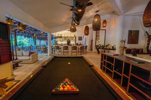 a living room with a pool table in the middle at The Beach Tulum Hotel in Tulum