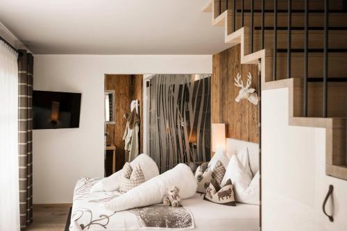 a living room with a white couch and a mirror at Alpine Boutique Villa Gabriela - Adults Only in Castelrotto