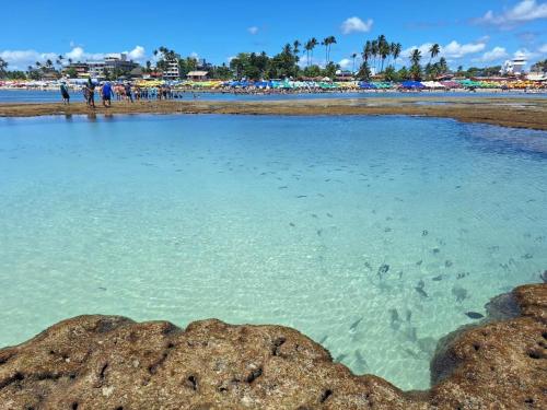 a large pool of water on a beach at Flat Novo no Centro de Porto de Galinhas in Porto De Galinhas
