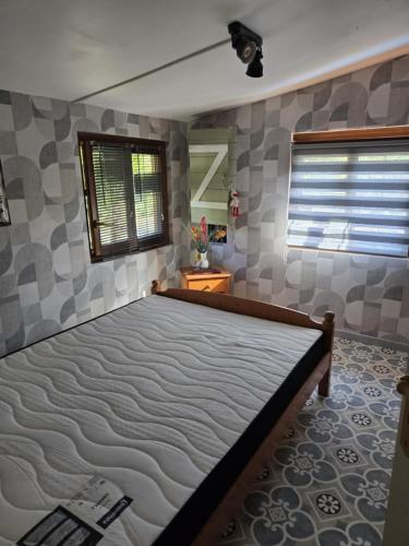 a bedroom with a large bed in a room at Chalet piscine chauffée et couverte in Brimeux