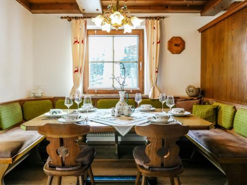 a dining room with a table and chairs and a window at Mountain Residence Riesgut - Sound of Music in Werfen