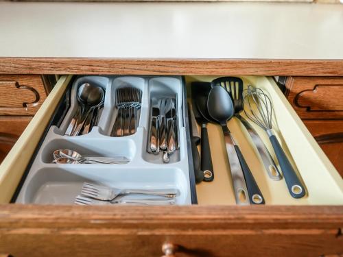 a drawer filled with utensils in a wooden cabinet at Mountain Residence Riesgut - Sound of Music in Werfen