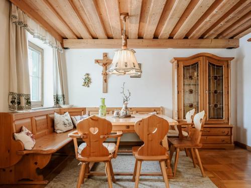 a dining room with a wooden table and chairs at Mountain Residence Riesgut - Sound of Music in Werfen