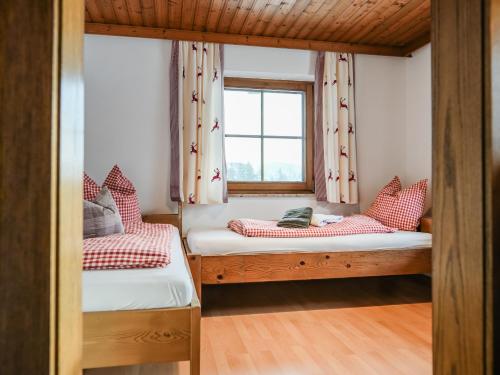 two bunk beds in a room with a window at Mountain Residence Riesgut - Sound of Music in Werfen