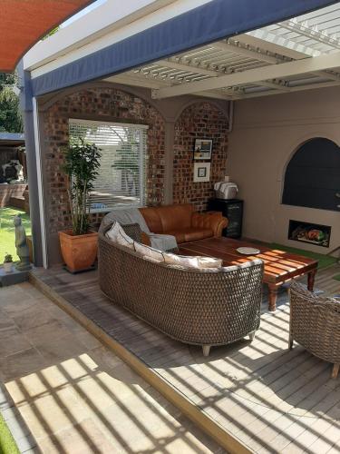 a patio with a couch and a table at Simply The Choice Manor in Panorama