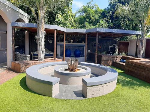 a patio with a fountain in the grass at Simply The Choice Manor in Panorama