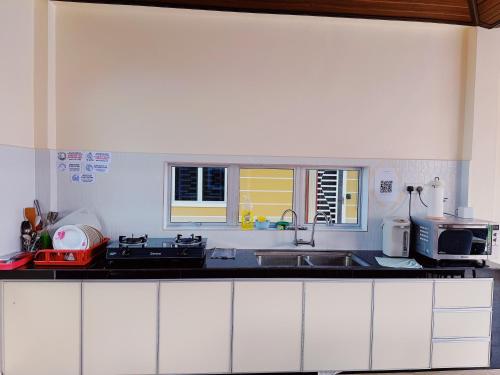 a kitchen with a sink and a counter top at Tokwan Homestay, Alor Setar Kedah in Alor Setar