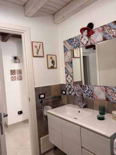 a bathroom with a sink and a mirror at Casa Cibella Authentic Charme Apartments in Agrigento
