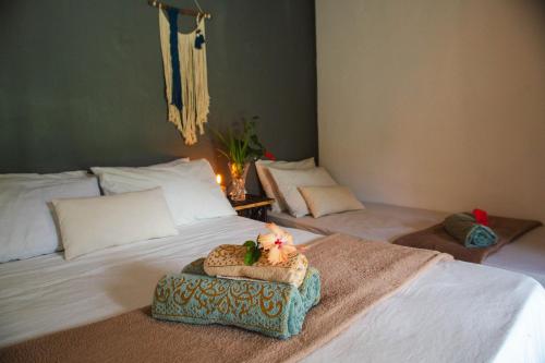 a bedroom with a bed with a tray on it at Caju com Mel Hospedagem in Moreré