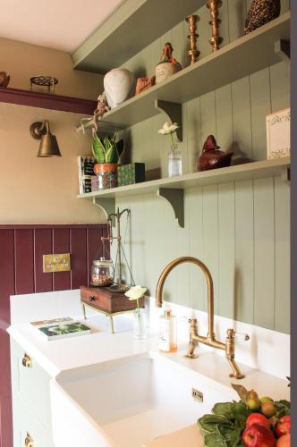 a kitchen with a sink and some shelves at 100 year old family farmhouse in Oldcastle