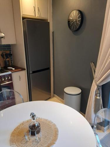a kitchen with a white table and a refrigerator at Simply The Choice Manor in Panorama