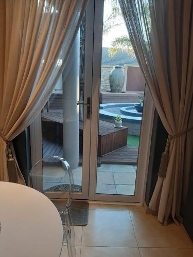 a sliding glass door with a view of a pool at Simply The Choice Manor in Panorama