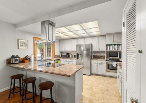 a kitchen with white cabinets and stainless steel appliances at @ Marbella Lane - 4BR Cozy home in SJ Pool in San Jose