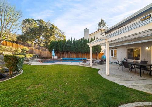 a backyard with a pool and a patio at @ Marbella Lane - 4BR Cozy home in SJ Pool in San Jose