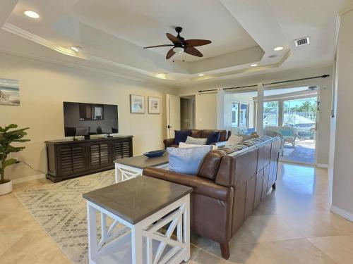 a living room with a couch and a ceiling fan at Waterside Villa in Bailey Hall