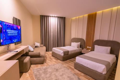 a hotel room with two beds and a flat screen tv at Elevana Boutique hotel in Cairo