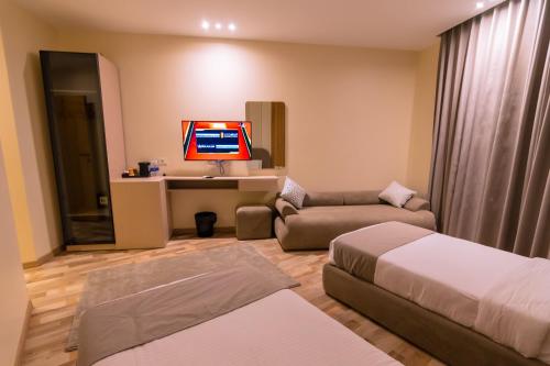 a hotel room with a couch and a tv at Elevana Boutique hotel in Cairo
