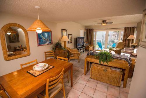 a living room with a table and a dining room at Pier Point South Ocean View Condo B-14 in Saint Augustine Beach