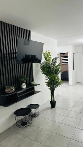 a room with two chairs and a tv on a wall at Comfortable house in Zaragoza