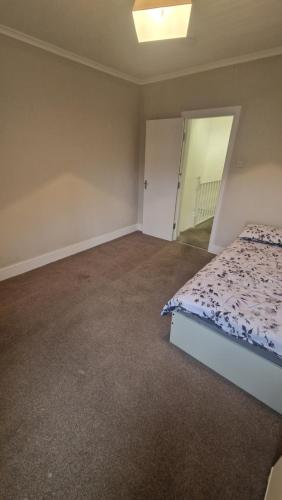 an empty bedroom with a bed and a mirror at Terrace house in Belvedere