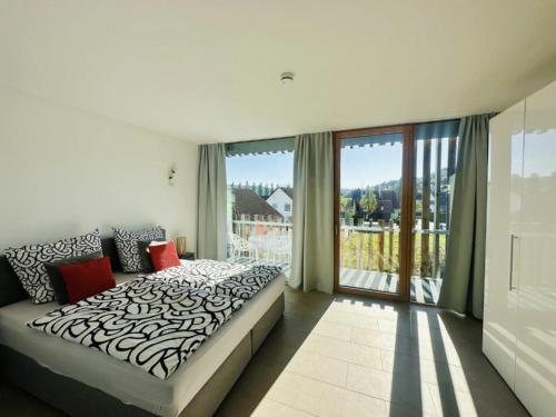 a bedroom with a bed and a large window at Penthouse Panorama Deluxe - Seesicht - BBQ - Beach Paradise - Loft Premium in Öhningen