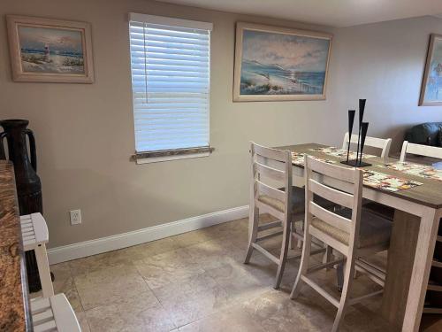 a kitchen with a table with chairs and a window at Pier Point South Oceanfront Condo A-1 in Saint Augustine Beach