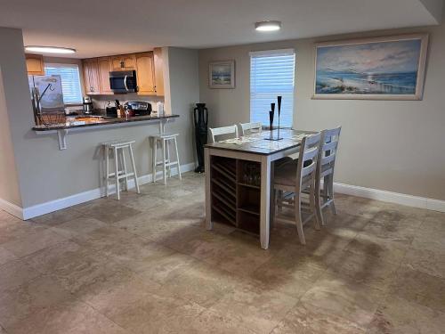 a kitchen and dining room with a table and chairs at Pier Point South Oceanfront Condo A-1 in Saint Augustine Beach