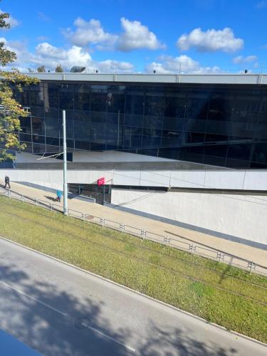 a large glass building with a road in front of it at Fabulous Central Apartment in Daugavpils