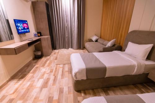 a hotel room with a bed and a couch at Elevana Boutique hotel in Cairo