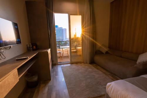 a hotel room with a bed and a couch and a window at Elevana Boutique hotel in Cairo