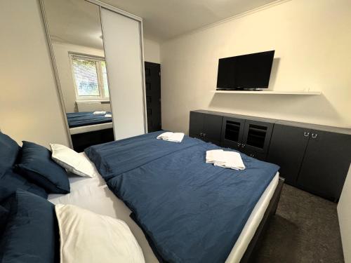 a bedroom with two beds and a flat screen tv at 3 Bedroom Apartment, Playground, bounce mat jump ring in Poruba