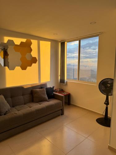 a living room with a couch and a window at Duplex La Mesa Cundinamarca in La Mesa