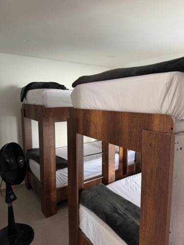 two bunk beds in a room with a fan at Duplex La Mesa Cundinamarca in La Mesa