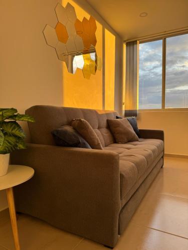 a brown couch in a living room with a window at Duplex La Mesa Cundinamarca in La Mesa