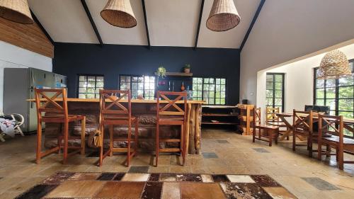 a dining room with a wooden table and chairs at DesertDewEstate in Nanyuki
