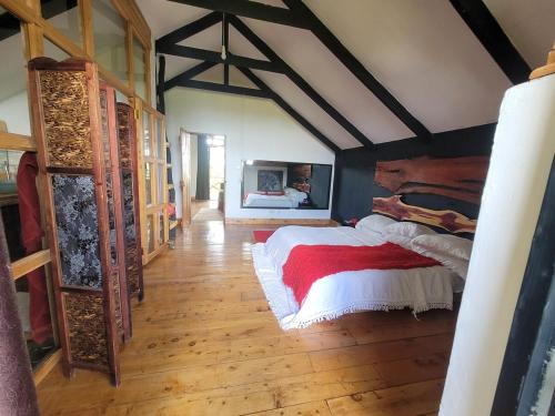 a bedroom with a bed in a room with wooden floors at DesertDewEstate in Nanyuki