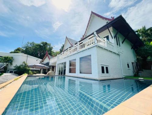 une villa avec piscine devant une maison dans l'établissement Jaokhun Bayview Kamala, Phuket, à Kamala Beach