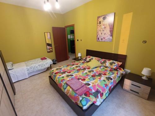 a bedroom with a large bed and a small bed sidx sidx sidx at Dimora Accorsi in Ferrara