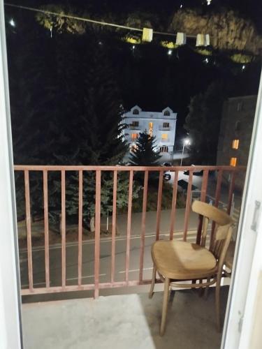 a chair sitting on a balcony at night at Apartment in Jermuk in Jermuk